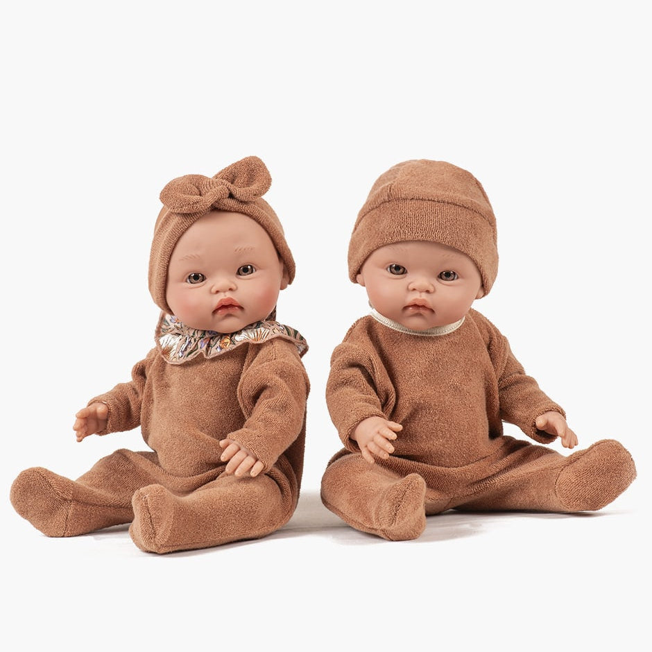 US stockist of Minikane's Octave Cuties doll dressed in Brown Sugar sleepsuit with matching Tico hat.