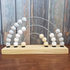 US stockist of Children of Trees hand made, hand painted wooden abacus rainbow counter in pale grey.